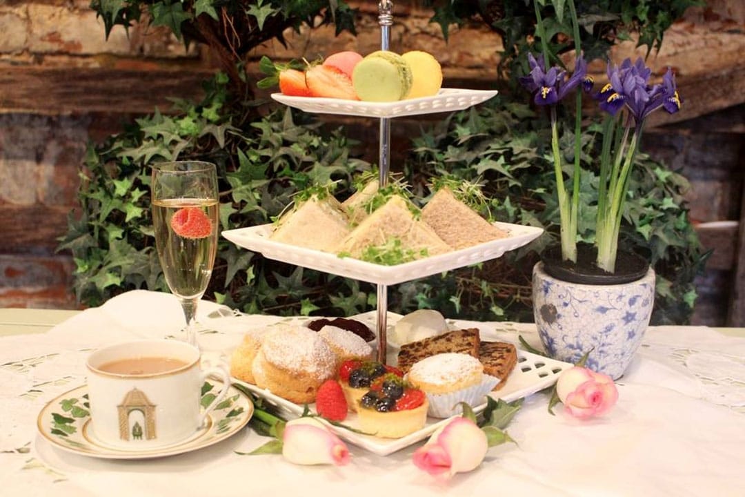A three tiered tray with food on it
Description automatically generated